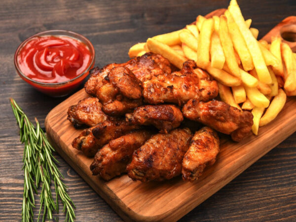 lunch fast food chicken wings with ketchup and potatoes fries